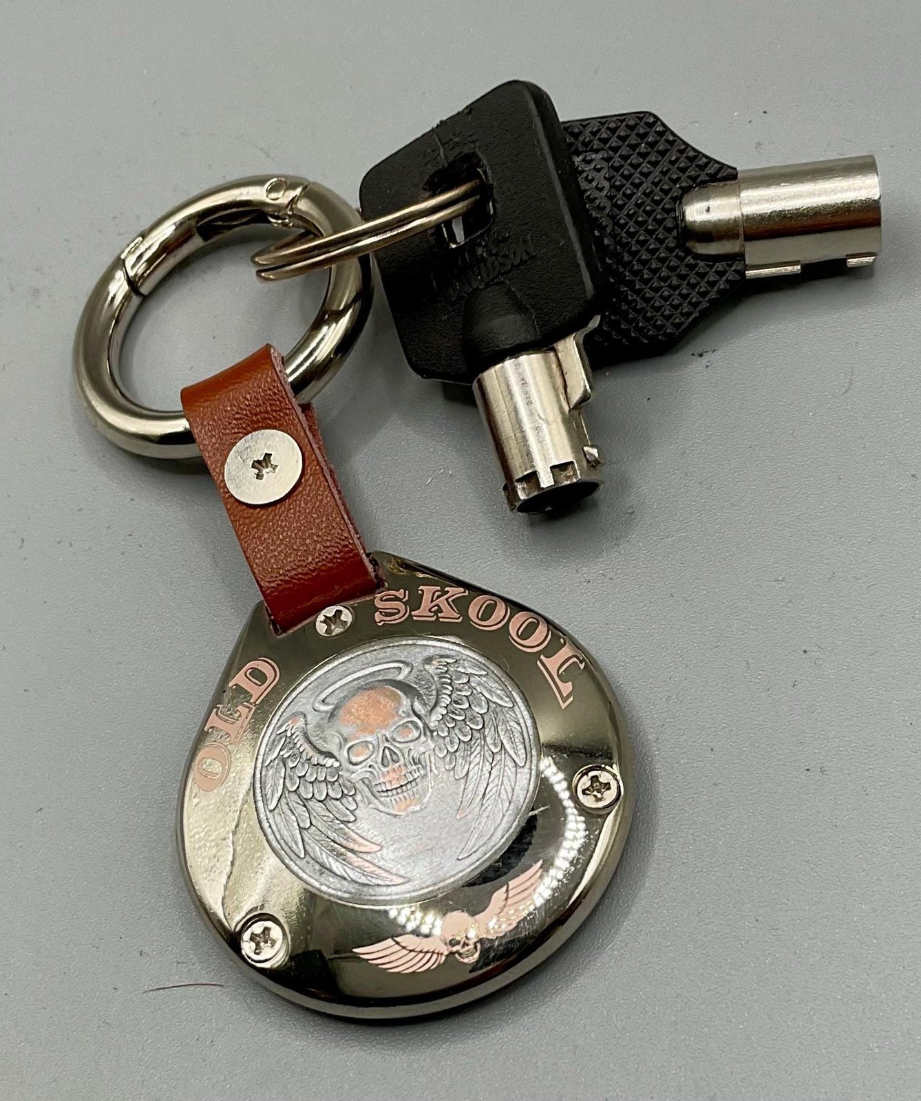 Harley “Old Skool” Sculpted AirTag Holder – Handmade Metal Keychain for Riders (AirTag Not Included) custom engraved motorcycle accessory shown in product photos by The Steel Canvas SKU HD-KEY-01